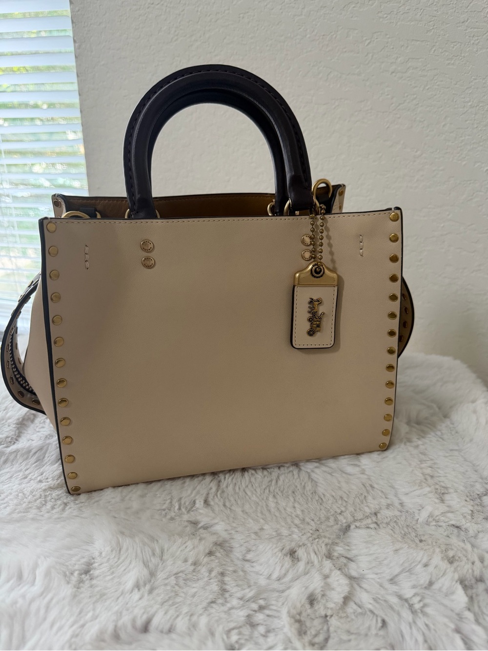 Coach Rogue 25 with Rivets.